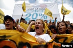 Opposition supporters shout slogans, during a gathering to demand a referendum to remove President Nicolas Maduro, in Caracas, Venezuela, July 9, 2016.