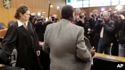 FILE - Onesphore Rwabukombe, 53, is photographed by media as he waits for the beginning of his trial at a court in Frankfurt, central Germany, Jan 18, 2011.