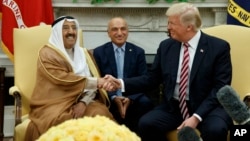 President Donald Trump shakes hands with Amir of Kuwait Sheikh Sabah Al Ahmad Al Saba during a meeting in the Oval Office of the White House, Sept. 7, 2017, in Washington. 