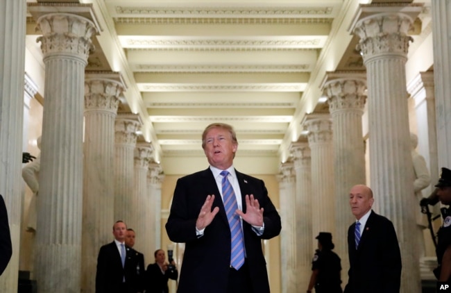 President Donald Trump speaks in the Hall of Columns as he arrives on Capitol Hill in Washington, Tuesday, June 19, 2018, to rally Republicans around a GOP immigration bill.