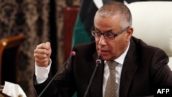 Libyan Prime Minister Ali Zeidan gives a press conference on November 10, 2013 in Tripoli. Zeidan warned Libyans of the possibility of foreign powers intervening unless the country's current chaos ends, in an appeal Sunday aimed at rallying his campaign a