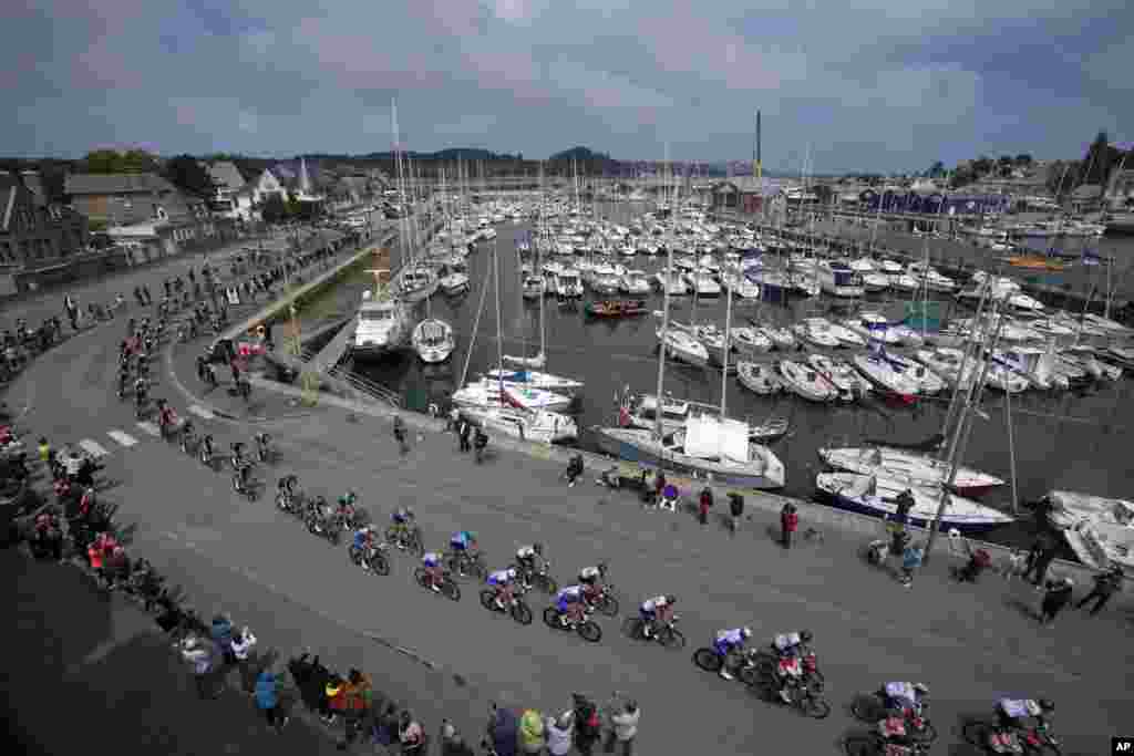 The pack rides during the second stage of the Tour de France cycling race over 219.9 kilometers (136.6 miles) with start in Perros-Guirec and finish in Mur-de-Bretagne Guerledan, western France.
