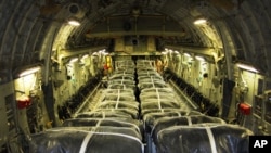 A U.S. Defense Department photo shows pallets of bottled water are loaded aboard a U.S. Air Force C-17 Globemaster III aircraft in preparation for a humanitarian airdrop over Iraq Aug. 8, 2014.
