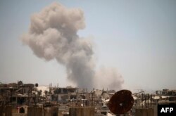 Smoke rises above opposition held areas of Daraa during airstrikes by Syrian regime forces on June 25, 2018.