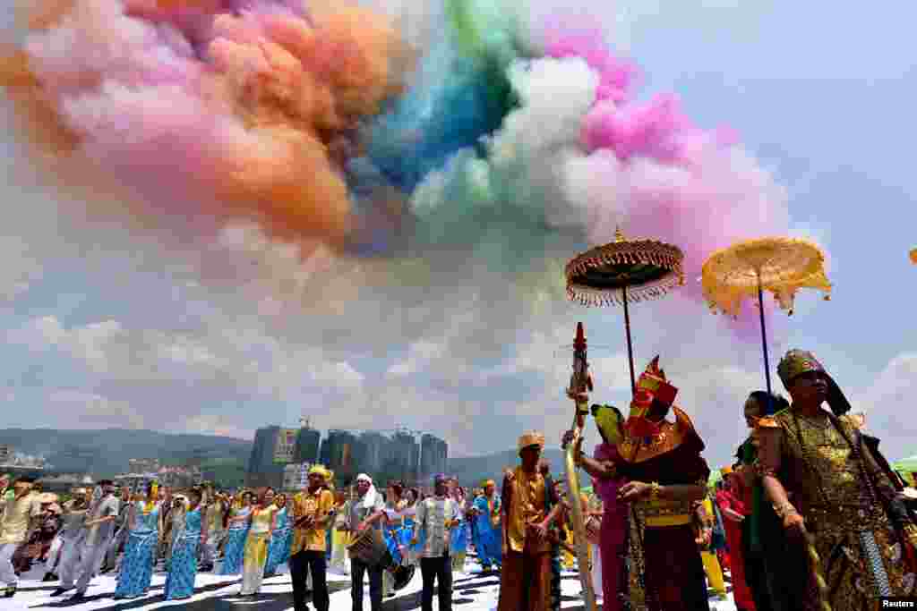 People wearing costumes attend the annual water-splashing festival to mark the New Year of the Dai minority in Jinghong, Yunnan province, China, April 13, 2015.