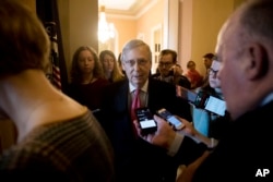 Senate Majority Leader Mitch McConnell of Ky. speaks to reporters as he walks into his office for a meeting with Senate Republicans on Capitol Hill in Washington, Jan. 10, 2019.