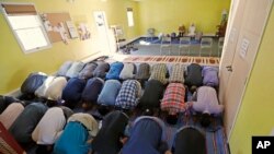 FILE – In this Sept. 23, 2016, photo, Muslim worshippers pray during a service at the Bernards Township Community Center in Basking Ridge, New Jersey.