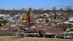 Emergency response workers dig through the rubble of the Mayfield Consumer Products candle factory in Mayfield, Ky., Dec. 11, 2021.