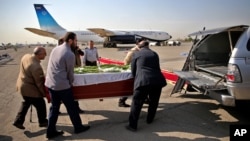 Petugas mengangkat peti jenazah seorang korban yang tewas dalam tragedi Mina di Arab Saudi, ke dalam mobil di bandar udara Mehrabad dii Teheran, Iran (3/10). (AP/Ebrahim Noroozi)