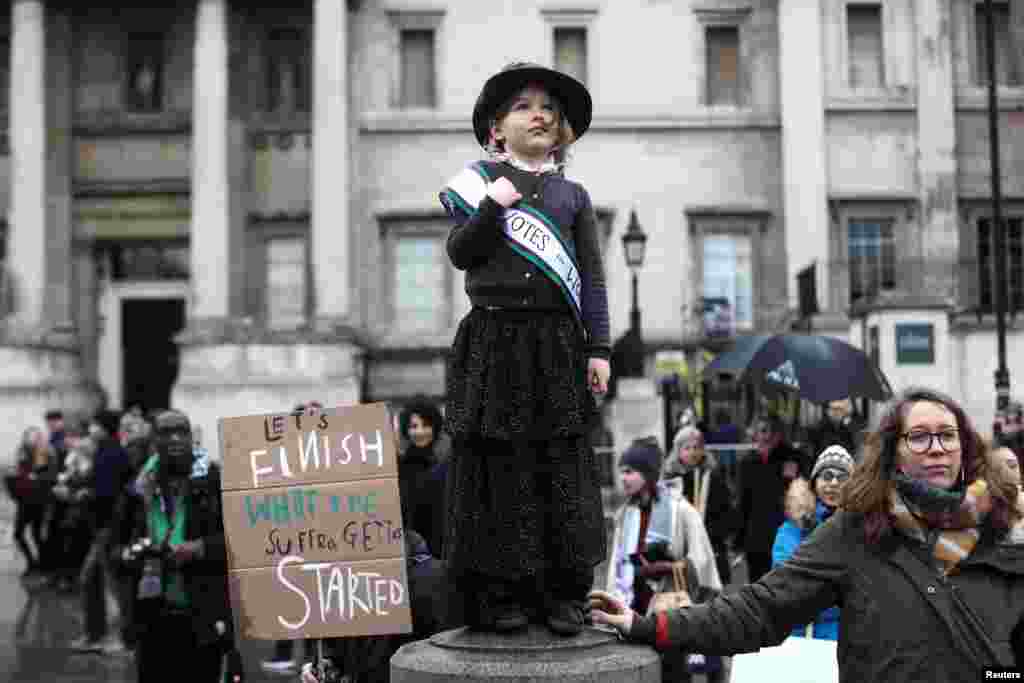 A child dressed as a suffragette demonstrates during the March4Women event in central London, March 4, 2018.