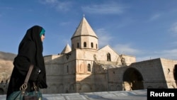 FILE - A woman visits Iran's St Thaddeus (Black Church), a medieval Armenian Christian place of worship, near Chaldoran, 650 km (404 miles) northwest of Tehran, close to the borders of Turkey and Armenia.