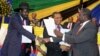 President Salva Kiir (l) and opposition leader Riek Machar (r) exchange copies of a peace deal agreed to in January 2015. At least 9 deals have been signed for South Sudan but none respected. 