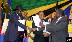 FILE - South Sudan's President Salva Kiir, left, is seen shaking hands with rebel leader Riek Machar, right, following a previous round of peace talks.