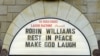 A man takes a photo of a the marquee of the Laugh Factory with a message in memory of actor Robin Williams displayed, in the Hollywood district of Los Angeles Monday, Aug. 11, 2014. 