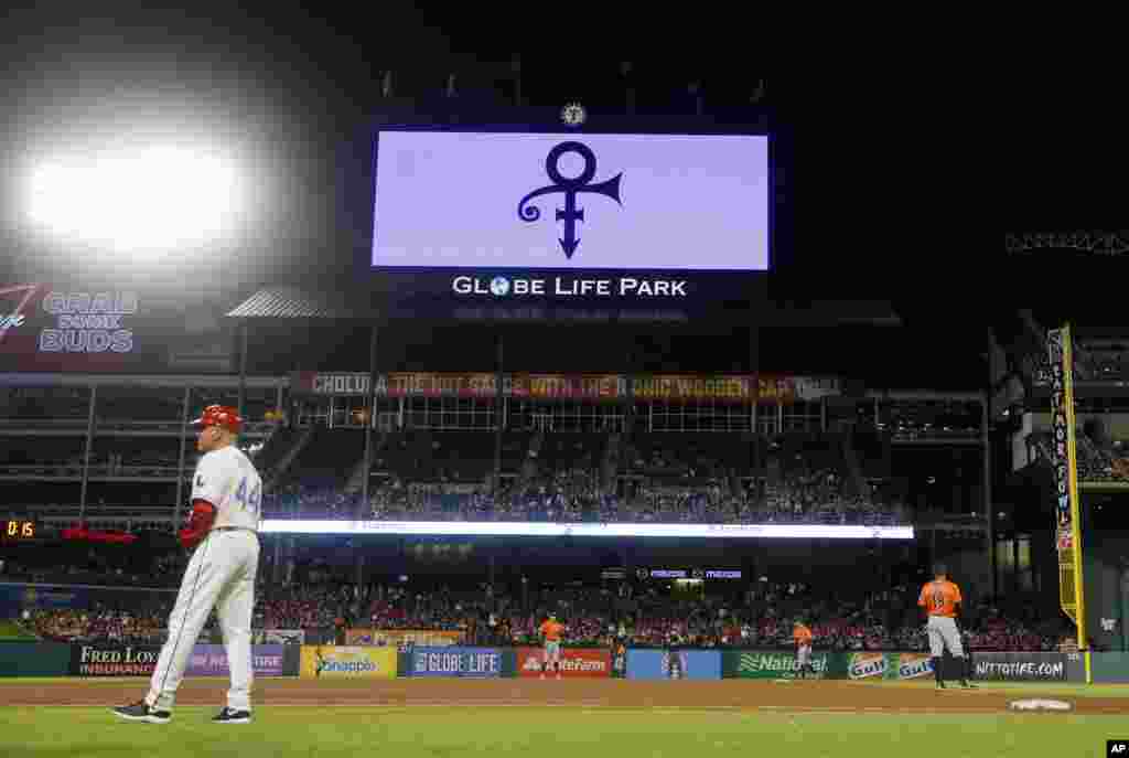 The Texas Rangers play the Houston Astros as the Rangers broadcast a symbol on the large video screen over the right field roof honoring singer Prince during a baseball game in Arlington, Texas, April 21, 2016.