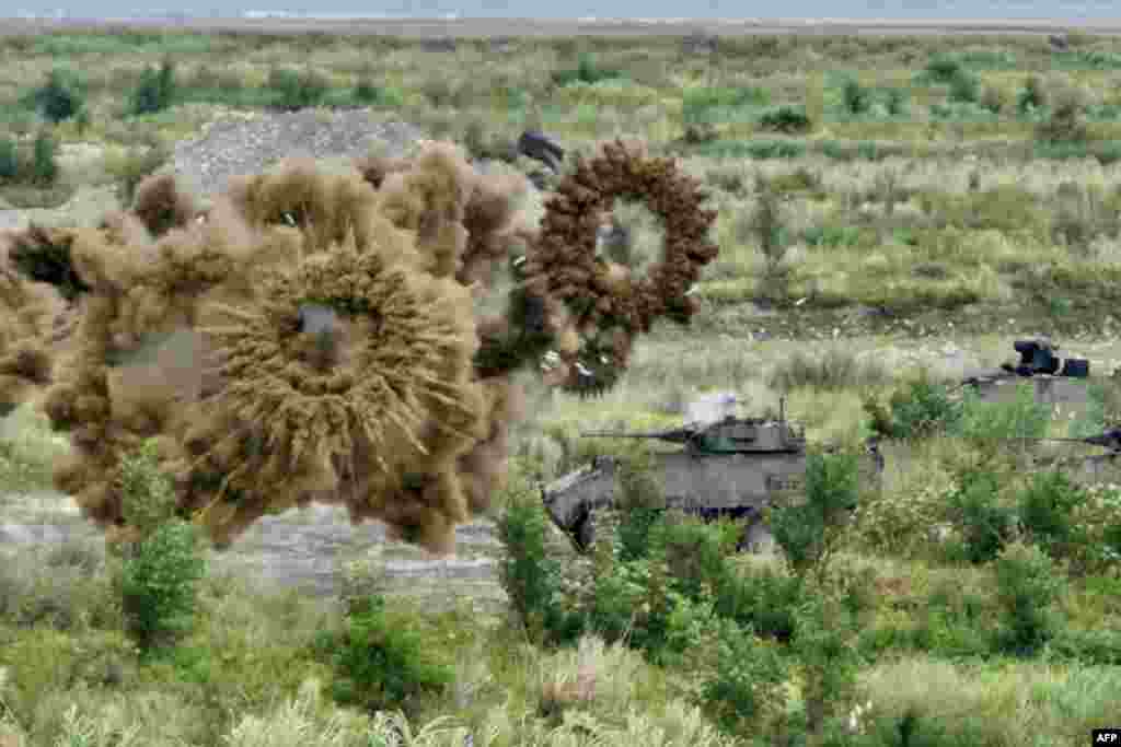 Two domestically-made armored vehicles launch smoke grenades during the annual Han Kuang military drills in Taichung, Taiwan.