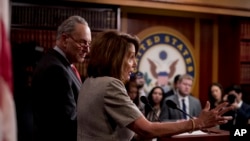 House Speaker Nancy Pelosi of Calif., accompanied by Senate Minority Leader Sen. Chuck Schumer of N.Y., left, speaks at a news conference on Capitol Hill in Washington, Jan. 25, 2019, after President Donald Trump announces a deal to reopen the government 