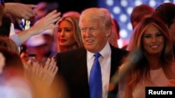 Republican U.S. presidential candidate Donald Trump arrives with his daughter Ivanka (L) and wife Melania (R) at his campaign victory party to speak to supporters after his rival Ted Cruz dropped out of the race following the results of the Indiana state primary, at Trump Tower in Manhattan, New York, U.S., May 3, 2016. REUTERS/Lucas Jackson