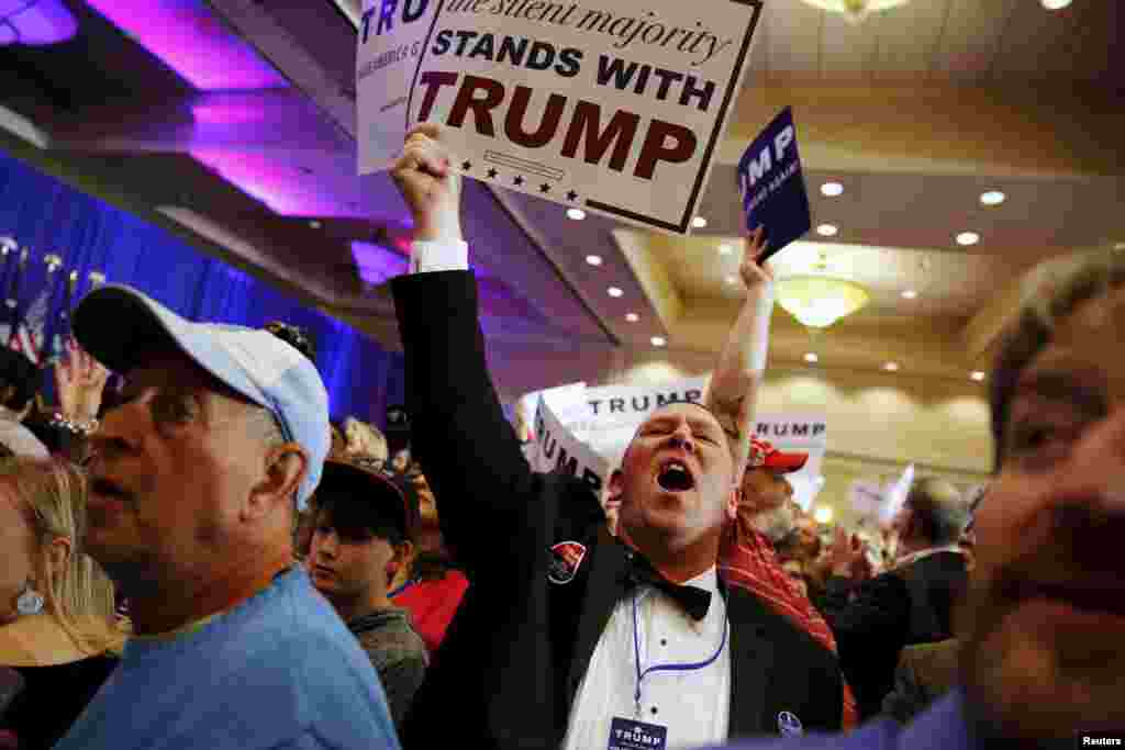 Supporters of U.S. Republican presidential candidate Donald Trump celebrate the close of the polls as they watch election results at a rally in Spartanburg, S.C., Feb. 20, 2016.