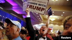 FILE - Supporters of U.S. Republican presidential candidate Donald Trump celebrate the close of the polls as they watch election results at a rally in Spartanburg, South Carolina, Feb. 20, 2016.