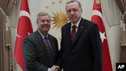 Turkey's President Recep Tayyip Erdogan, right, and U.S. Republican Senator Lindsey Graham shake hands before a meeting in Ankara, Turkey, Jan. 18, 2019. 