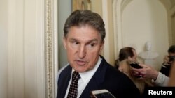 FILE - U.S. Senator Joe Manchin (D-WV) talks to reporters on Capitol Hill in Washington, Jan. 19, 2018.