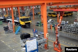 FILE - A factory floor of XCMG Group is seen in Xuzhou, Jiangsu province, China, Aug. 14, 2015. In the years since China unveiled a sweeping plan to rebuild Silk Road trade links with Europe and Asia, machinery maker XCMG Group has opened a factory in Uzbekistan, sent 300 staff abroad and set ambitious goals to grow overseas. XCMG's foreign venture piggybacks on China's bold scheme to extend its global influence through financing infrastructure projects in 65 nations that are home to two-thirds of humanity, and at the same time win new markets for companies weighed down by profit-crushing overcapacity at home.