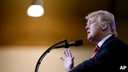 FILE - President Donald Trump speaks at a "Make America Great Again," rally at the Phoenix Convention Center, Aug. 22, 2017, in Phoenix, Arizona.