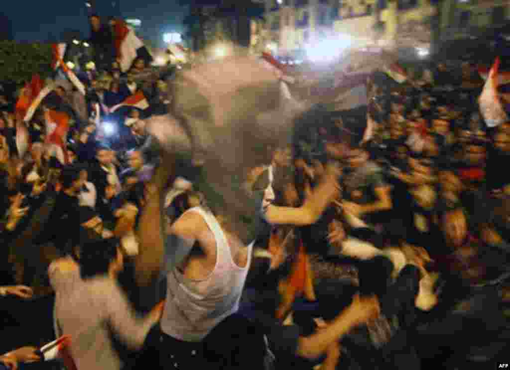 Egyptian citizens celebrate after President Hosni Mubarak resigned and handed power to the military at Tahrir Square, in Cairo, Egypt, Friday, Feb. 11, 2011. Egypt exploded with joy, tears, and relief after pro-democracy protesters brought down President 