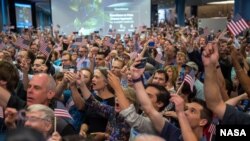 Guest and New Horizons team members countdown to the spacecraft's closest approach to Pluto, Tuesday, July 14, 2015 at the Johns Hopkins University Applied Physics Laboratory (APL) in Laurel, Maryland. Photo Credit: (NASA/Bill Ingalls)