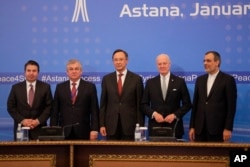 From left, Turkish Foreign Ministry Deputy Undersecretary Sedat Onal, Russia's special envoy on Syria Alexander Lavrentiev, Kazakh Foreign Minister Kairat Abdrakhmanov, UN Syria envoy Staffan de Mistura and Iran's Deputy Foreign Minister Hossein Jaber Ansari pose for a photo after the final statement following the talks on Syrian peace in Astana, Jan. 24, 2017.