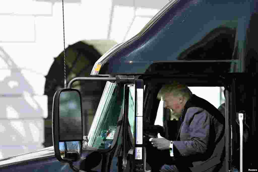 U.S. President Donald Trump reacts as he sits on a truck while he welcomes truckers and CEOs to attend a meeting regarding healthcare at the White House in Washington.