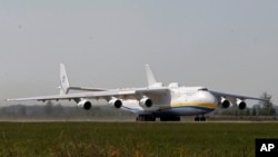 The world's largest airplane, Ukrainian Antonov An-225 Mriya takes off at the airport near Hostomel near Kiev , Ukraine, Tuesday, May 10, 2016. 