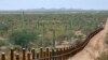 FILE - The international border line made up of bollards separating Mexico, left from the United States, in the Organ Pipe National Monument near Lukeville, Ariz., Feb. 17, 2006.