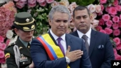 Colombia's President Ivan Duque gestures after receiving the presidential sash during his inauguration ceremony in Bogota, Colombia, Aug. 7, 2018.