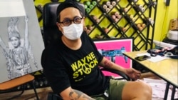 Thai artist who goes by "Headache Stencil" sits in his studio in Bangkok, Thailand, for an interview with VOA Thai.