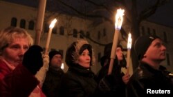 Demonstrators take part in a protest organized by a Jewish group against a planned statue honoring Hungarian Nazi-era minister Balint Homan in Szekesfehervar, Hungary, Dec. 13, 2015.