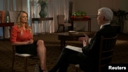 Stormy Daniels, an adult film star and director whose real name is Stephanie Clifford, is interviewed by Anderson Cooper of CBS News' "60 Minutes" program in early March 2018, in a still image from video provided March 25, 2018.