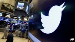 FILE - In this July 27, 2016, file photo, the Twitter symbol appears above a trading post on the floor of the New York Stock Exchange. Twitter, long criticized as a hotbed for online harassment, is expanding ways to curb the amount of abuse users see and making it easier to report such conduct. (AP Photo/Richard Drew, File)