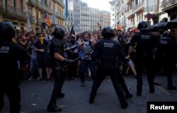Catalan separatists clash with Mossos d'Esquadra police officers during a protest in Barcelona, Spain, Sept. 29, 2018.