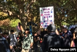 Signs supporting a planned speech by Milo Yiannopoulos in Berkeley, California on Sunday, Sept. 24, 2017 following a protest of another speech of his at the University of California, Berkeley earlier that year.