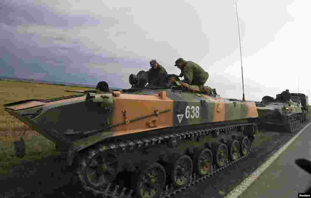 Russian servicemen sit on military vehicles by the roadside, outside Kamensk-Shakhtinsky, near the border with Ukraine, Rostov Region, Aug. 18, 2014.&nbsp;