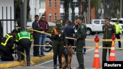 La policía trabaja cerca del lugar donde explotó un coche bomba, según las autoridades, en Bogotá.