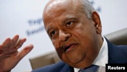 South Africa's Finance Minister Pravin Gordhan gestures during a media briefing after he was reappointed to the position by President Jacob Zuma in Pretoria, Dec. 14, 2015. 