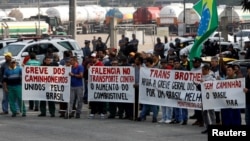 Truck owners block the main entrance of the gasoline and gas terminal in Barueri, Brazil, May 23, 2018. Signs read "Strike of the truckers united by Brazil."