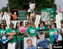 FILE - Families from across the U.S. living with autism take part in a rally calling for the elimination of toxins from children's vaccines in Washington, June 4, 2008.