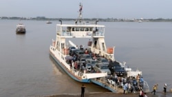 FILE - Passengers disembark from a ferry in Phnom Penh on March 3, 2020.