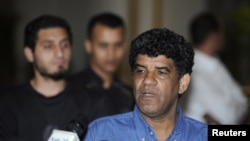 Abdullah al-Senussi, head of the Libyan Intelligence Service speaks to the media in Tripoli, August 21, 2011.