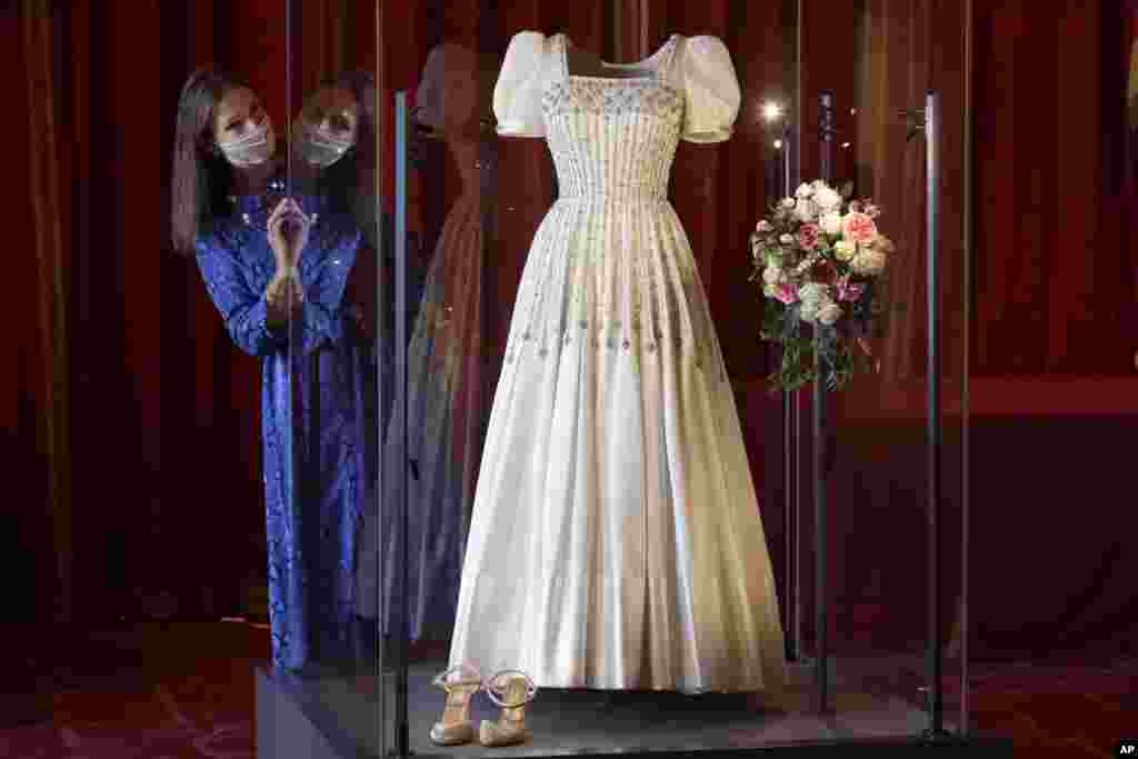 Caroline de Guitaut, Deputy Surveyor of The Queen&#39;s Works of Art, views Princess Beatrice&#39;s wedding dress, originally worn by Britain&#39;s Queen Elizabeth in the 1960s, ahead of it going on public display at Windsor Castle, Windsor, Britain.