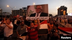 People shout slogans during a demonstration to show support for Iraqi Prime Minister Haider al-Abadi at Tahrir Square in central Baghdad, Aug., 9, 2015. 